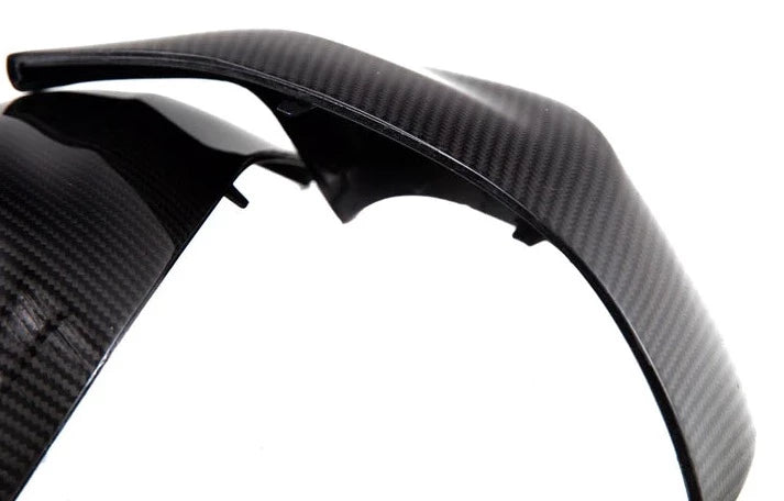 A close up view of AUTOTECKNIC REPLACEMENT DRY CARBON MIRROR COVERS - BMW G09 XM 2022+ with white background