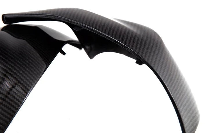 A close up view of AUTOTECKNIC REPLACEMENT DRY CARBON MIRROR COVERS - BMW F95 X5M | F96 X6M 2019+ with white background