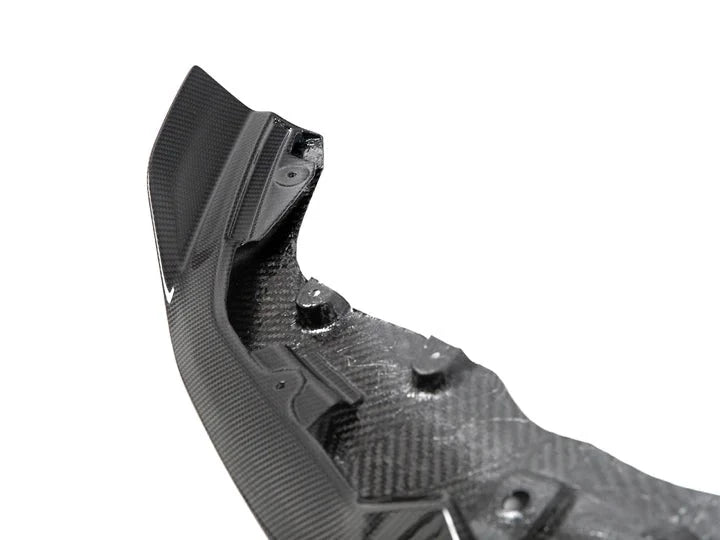 A close up view of AUTOTECKNIC DRY CARBON COMPETITION FRONT AERO LIP - BMW F87 M2 COMPETITION 2018+ with white background