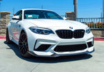A wide front view of AUTOTECKNIC DRY CARBON COMPETITION FRONT AERO LIP - BMW F87 M2 COMPETITION 2018+ fitted on a white car