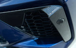 A close up view of AUTOTECKNIC PERFORMANCE DRY CARBON BUMPER TRIM SET - BMW F95 X5M Pre-LCI 2019-2021 fitted on a blue car