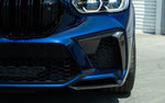 A close up front view of a blue car fitted with AUTOTECKNIC PERFORMANCE DRY CARBON BUMPER TRIM SET - BMW F95 X5M Pre-LCI 2019-2021