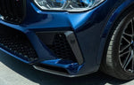 A close up view of a blue car fitted with AUTOTECKNIC PERFORMANCE DRY CARBON SPLITTER SET - BMW F95 X5M 2019+