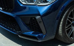 A close up side view of a blue car fitted with AUTOTECKNIC PERFORMANCE DRY CARBON BUMPER TRIM SET - BMW F95 X5M Pre-LCI 2019-2021