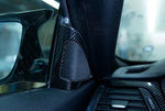 A close up view of AUTOTECKNIC CARBON FIBER SPEAKER TWEETER COVER for BMW models fitted in a car