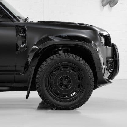 Close-up of an Urban WX4 satin black wheel on a Defender front corner (arch extension shown is not included)