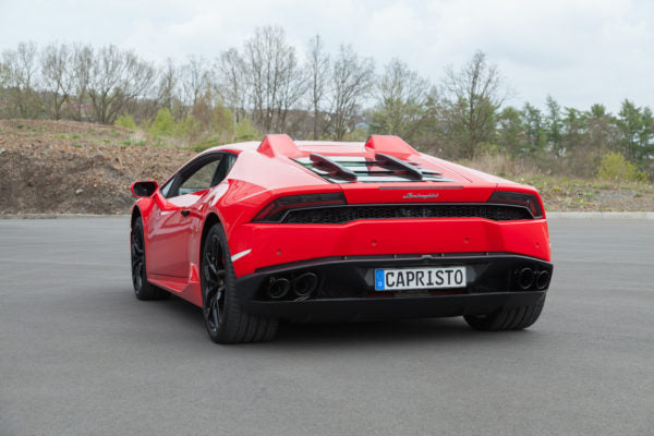 wide back view of Capristo Carbon Engine Bonnet/Hood (With Scoops) Matte for Lamborghini Huracan 2014-2019 fitted inside a red car