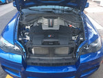 A top view of RK Autowerks E70 E71 X5M X6M CARBON FIBER INTAKES fitted on a blue car