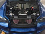 A top view of RK Autowerks E70 E71 X5M X6M CARBON FIBER INTAKES fitted on a blue car