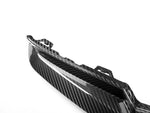 A close up view of AUTOTECKNIC DRY CARBON OEM-SPEC REAR SPLITTER SET - BMW G80 M3 | G82/ G83 M4 2021+ with white background