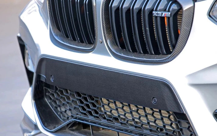 A close up view of a car fitted with AUTOTECKNIC DRY CARBON FIBER BUMPER TRIM - F97 X3M | F98 X4M PRE-LCI 2019-2021