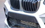 A close up view of a car fitted with AUTOTECKNIC DRY CARBON FIBER BUMPER TRIM - F97 X3M | F98 X4M PRE-LCI 2019-2021