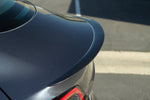 A back close up view of a car fitted with APR Performance Rear Deck Spoiler Tesla Model 3 2017-2023
