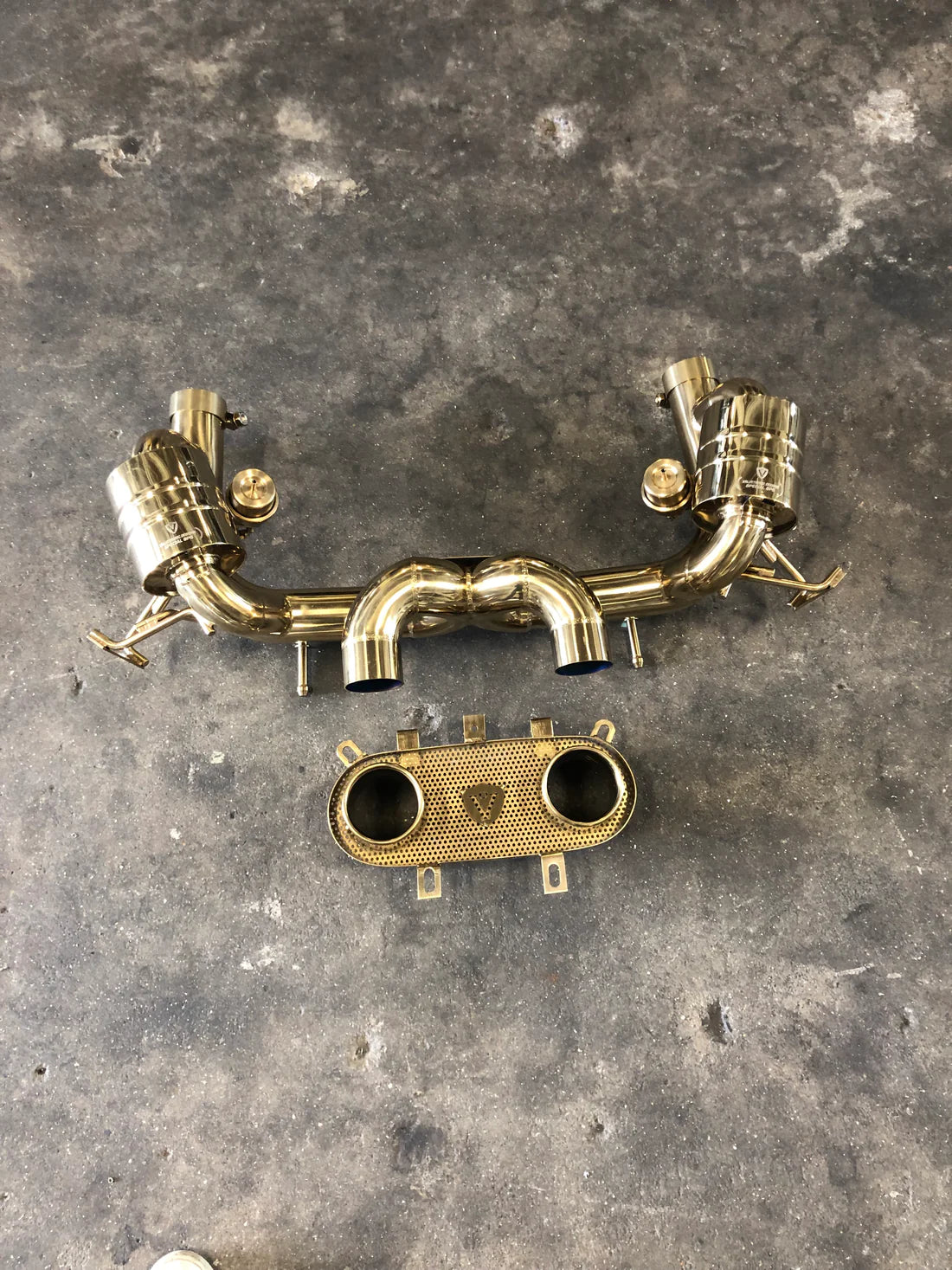 A wide overview of Valvetronic Designs Valved Sport Exhaust System on the ground (for Ferrari 458 Italia).