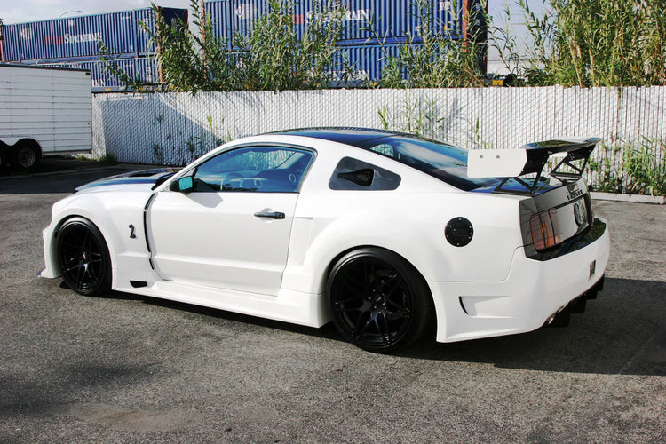 A side wide view of a white car fitted with APR Performance GT-R Widebody Aerodynamic Kit Ford Mustang Shelby GT500 2007-2009