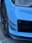 A side close up view of a blue car fitted with APR Performance Carbon Fiber Front Bumper Canards for BMW G87 M2 2023+