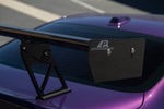Black carbon fiber rear spoiler with adjustable uprights mounted on purple BMW trunk lid - APR Performance wing for BMW G42 M240i G87 M2