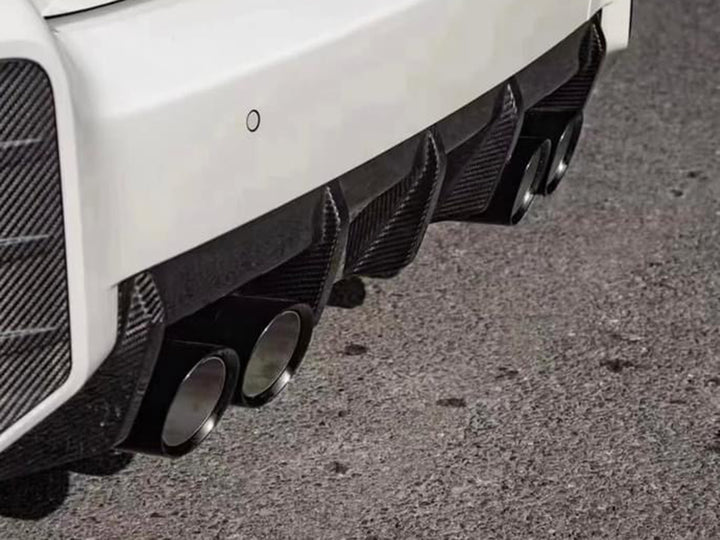 A close up view of AUTOTECKNIC DRY CARBON PERFORMANTE REAR DIFFUSER - BMW G87 M2 2023+ fitted on the car