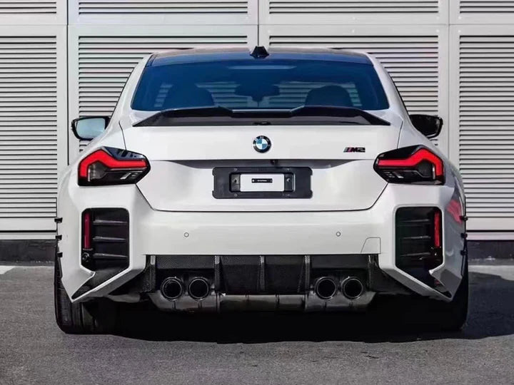 A wide view of AUTOTECKNIC DRY CARBON PERFORMANTE REAR DIFFUSER - BMW G87 M2 2023+ fitted on a car