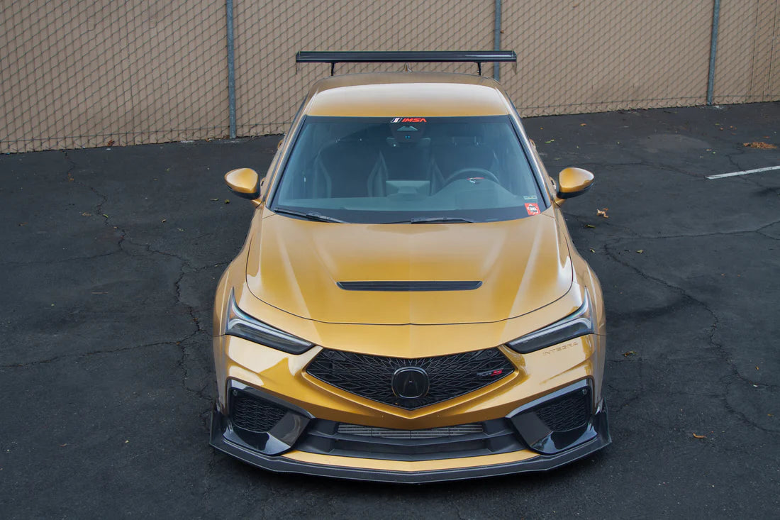 A front wide view of APR Performance GT-250 Carbon Fiber Adjustable Wing for Acura DE5 Integra Type S 2024+ fitted on a golden car on the ground