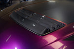A close up view of APR Performance Carbon Fiber Hood Vent for Ford Mustang S650 2024+ fitted on a purple car