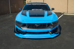 A front wide view of APR Performance Front Bumper Canards for Ford Mustang S650 Dark Horse 2024+ fitted on a blue car on the ground