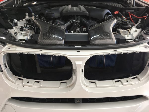 A front wide view of RK Autowerks F85 F86 X5M & X6M CARBON FIBER INTAKES fitted on a car