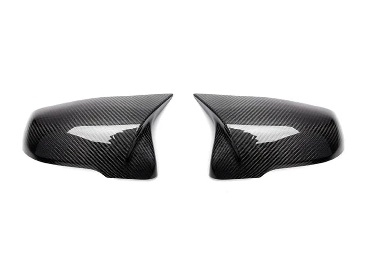 A front view of AUTOTECKNIC REPLACEMENT AERO CARBON MIRROR COVERS - TOYOTA A90 SUPRA 2020+ with white background