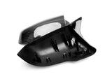 A close up view of AUTOTECKNIC M-INSPIRED CARBON FIBER MIRROR COVERS - BMW F06/ F12/ F13 6-SERIES 2014-2016 with white background