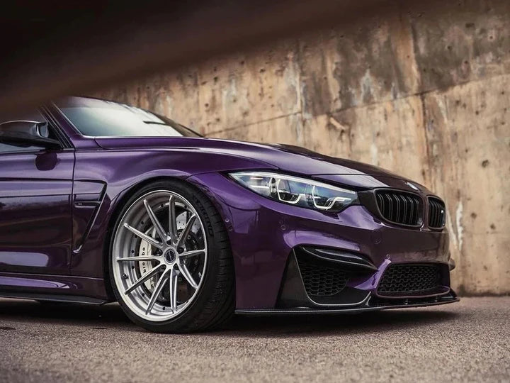 A side view of AUTOTECKNIC DRY CARBON CORSA BUMPER TRIM - BMW F80 M3 | F82/ F83 M4 2014+ fitted on a purple car