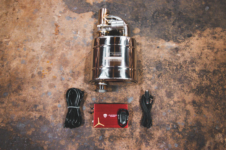 A top overview of Valvetronic Designs UNIVERSAL Valved Muffler Kit on the ground with wires and red box.