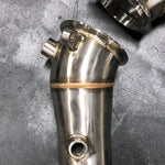A close up view of RK Autowerks F10 F12 M5 M6 CATLESS DOWNPIPES on a table