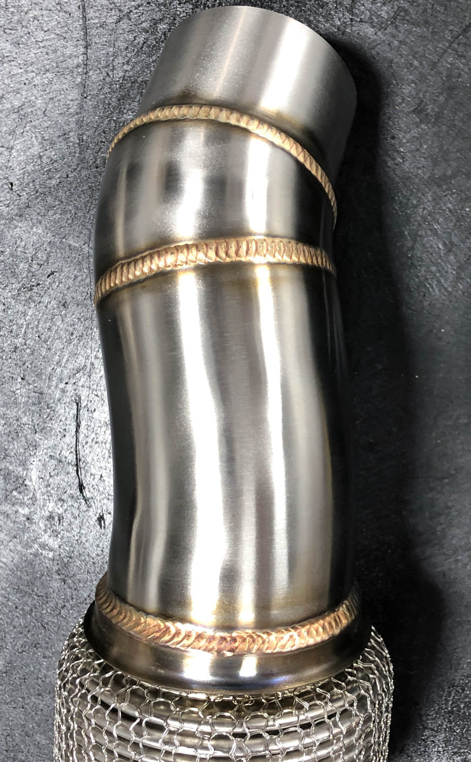 A close up view with RK Autowerks F10 F12 M5 M6 CATLESS DOWNPIPES on a table