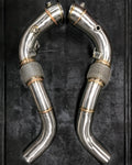 A top view of RK Autowerks F85 F86 X5M X6M CATLESS DOWNPIPES with a black background