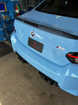 A back view of Valvetronic Designs Valved Sport Exhaust System fitted on a lifted blue car (for BMW G87 M2).