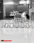 A front wide view of Unfinished Aluminum of the RK Autowerks S58 BILLET PORT INJECTION MANIFOLD on a table
