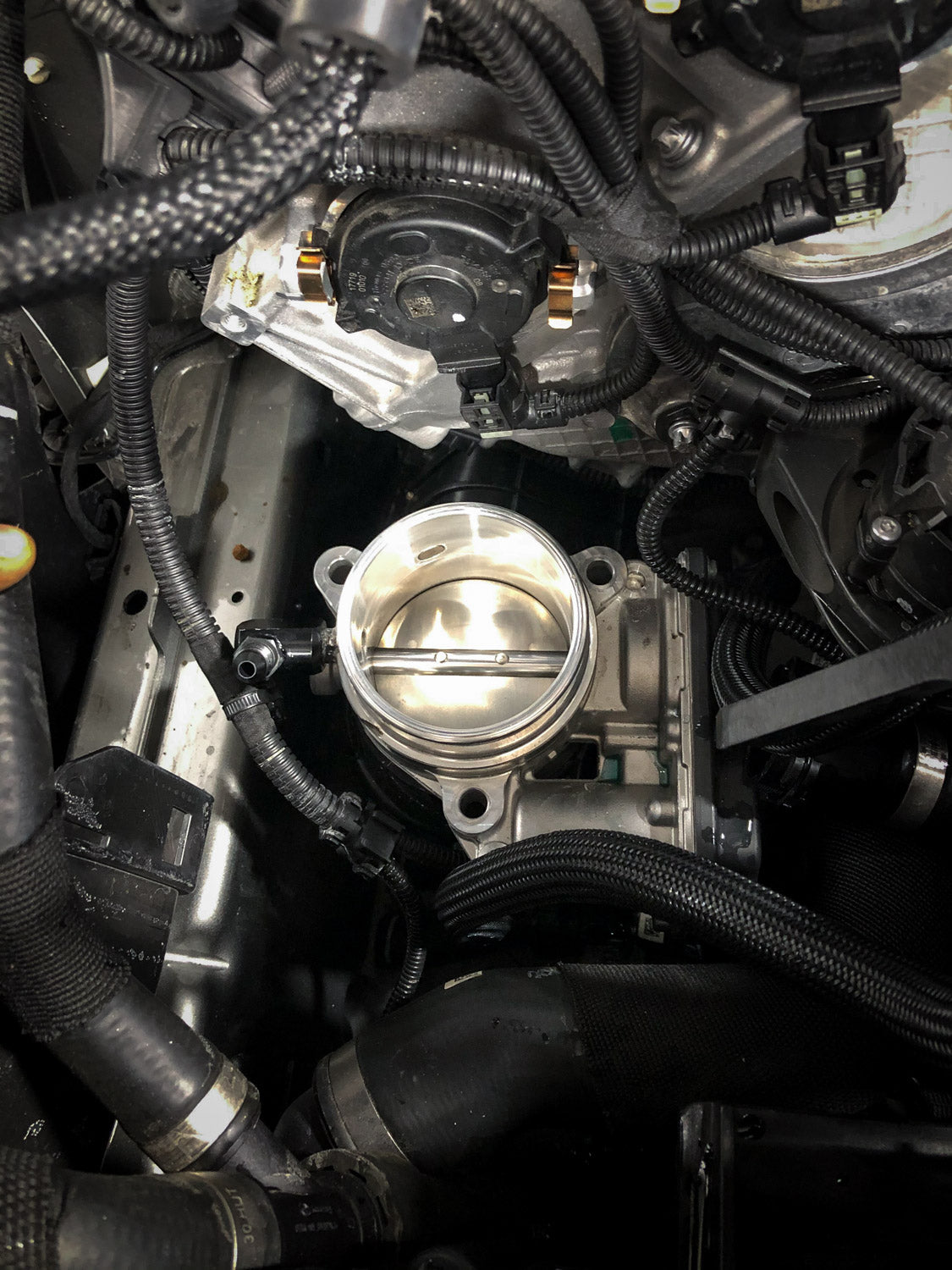 A top view of RK Autowerks F90 F92 M5 M8 BILLET METHANOL NOZZLE ADAPTERS fitted on a car