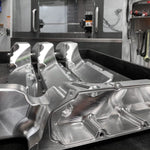 A front view of RK Autowerks F9X M5 M8 BILLET INTAKE MANIFOLDS on a table