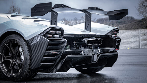 wide side view of Capristo Valved Exhaust with Heat Shield and Carbon/Stainless Exhaust Finisher for KTM X-Bow GT-XR 2008-2019 fitted inside a car