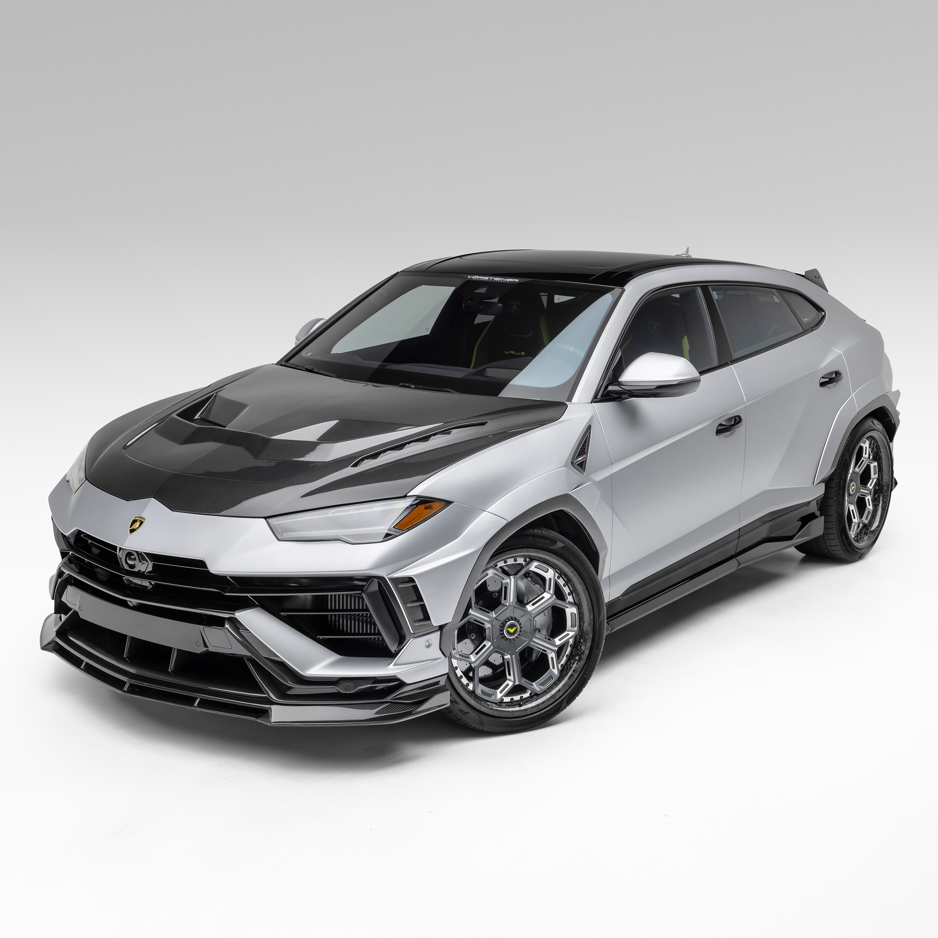 Grey Urus Performante fitted with carbon hood, front 3/4 view