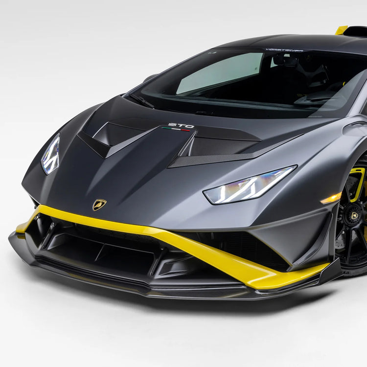 A side wide view of a car fitted with Vorsteiner Aero Front Spoiler Carbon Fiber for Lamborghini Huracan STO 2021-2025 with white background