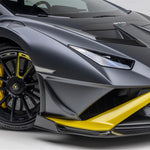 A side close up view of a car fitted with Vorsteiner Aero Front Spoiler Carbon Fiber for Lamborghini Huracan STO 2021-2025 with white background