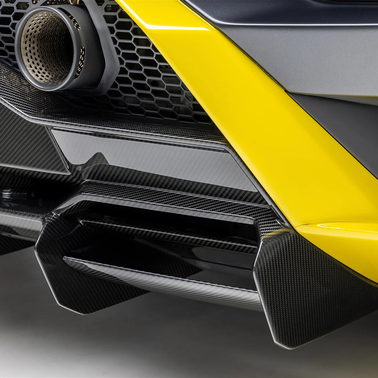 A back close up view of a car fitted with Vorsteiner Aero Rear Diffuser Carbon Fiber for Lamborghini Huracan STO 2021-2025 