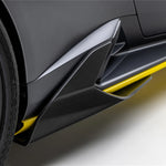 A side close up view of the bottom of a car fitted with Vorsteiner Aero Side Skirts Carbon Fiber for Lamborghini Huracan STO 2021-2025 