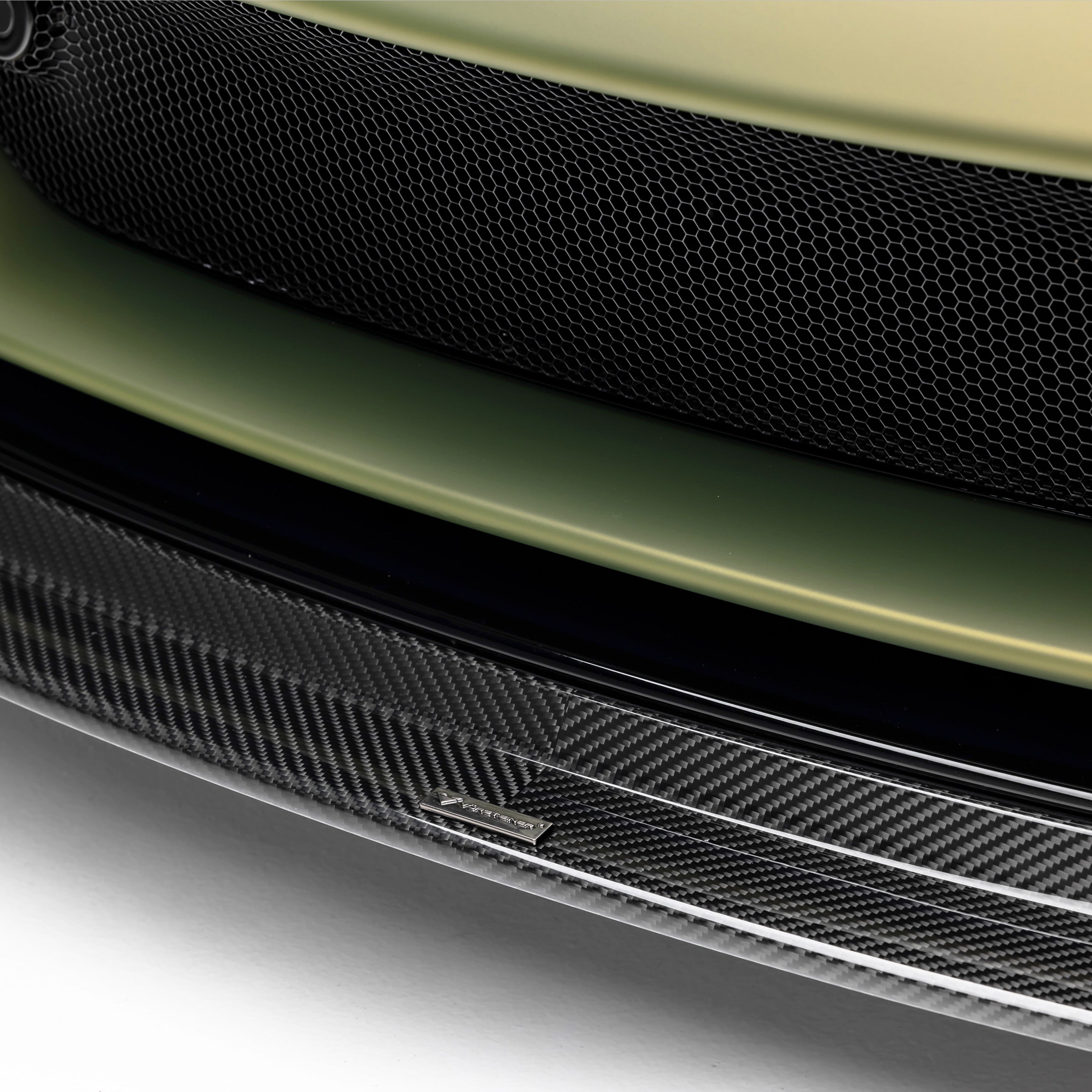 Carbon front lip under Emira intake, straight-on detail
