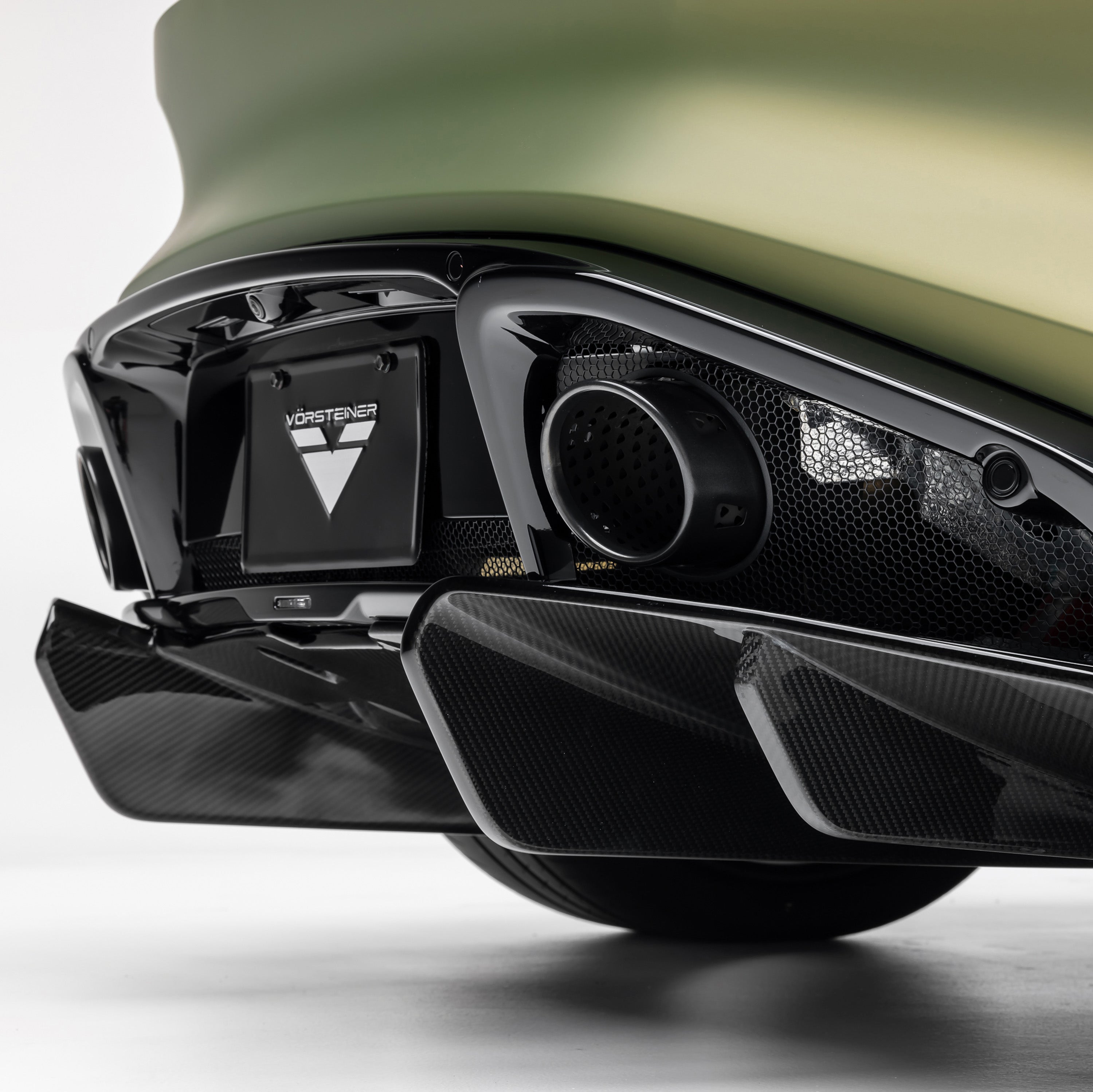 Carbon diffuser fins under Emira bumper, low close-up
