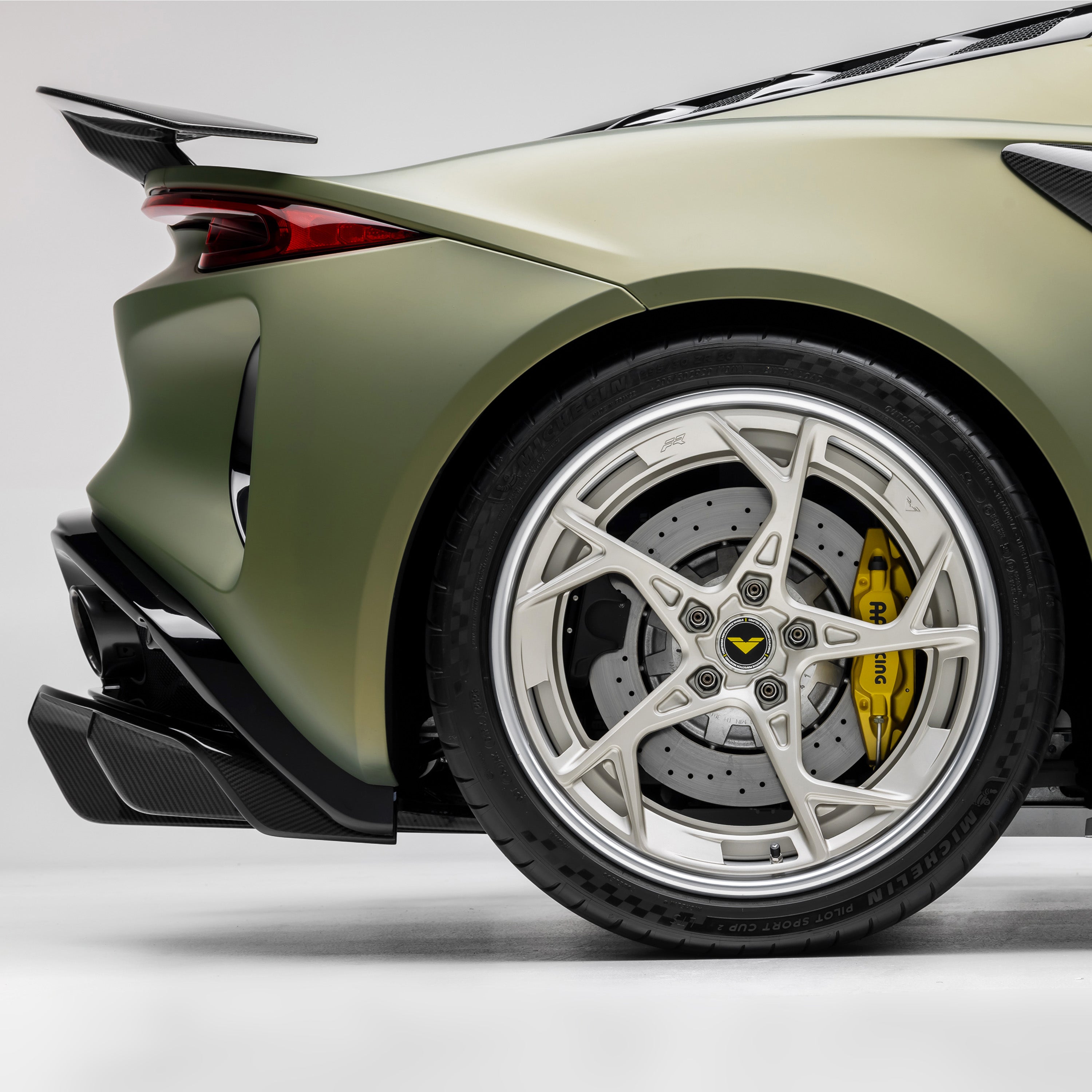 Emira rear wing side profile with rear wheel, close-up