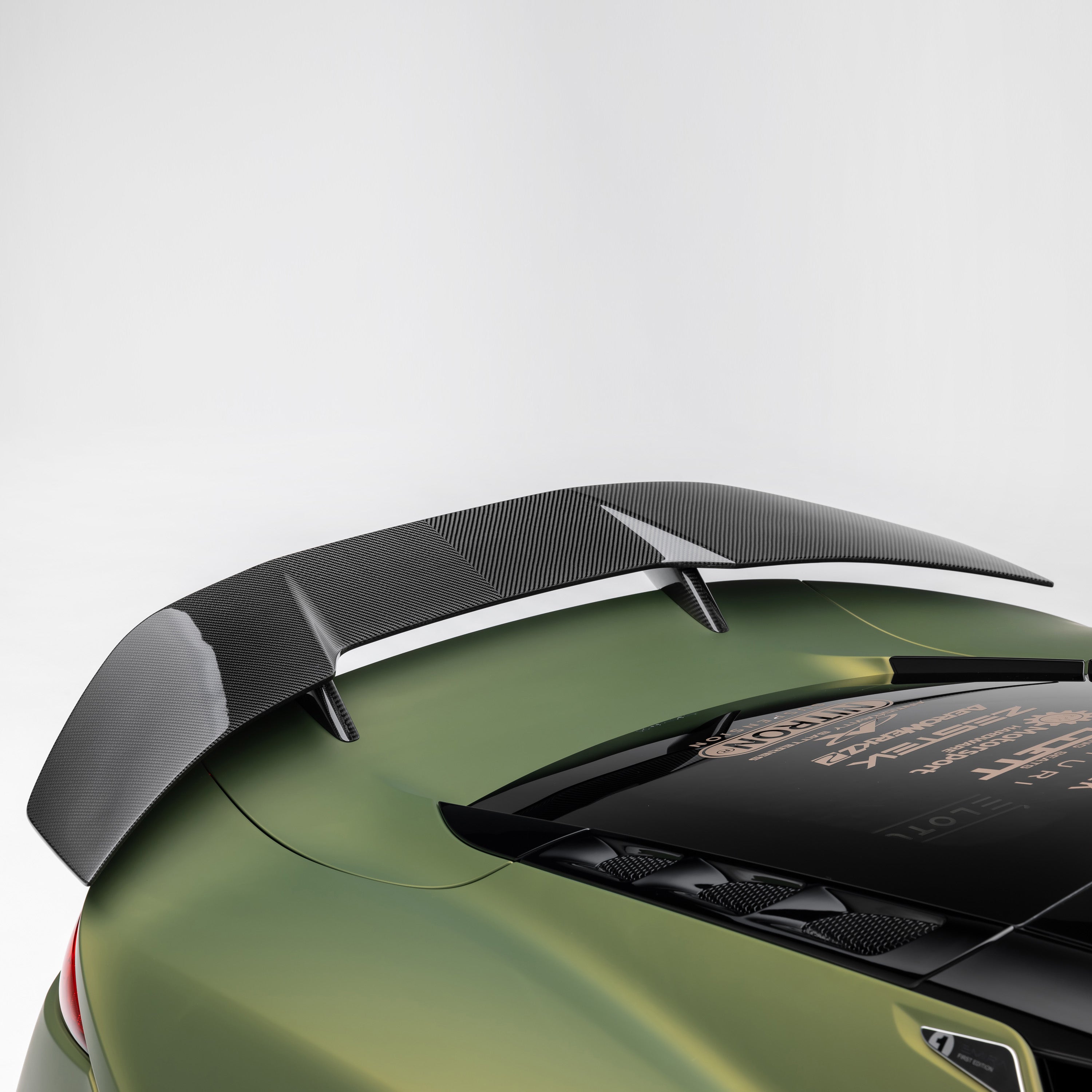 Emira carbon wing over engine cover, side view