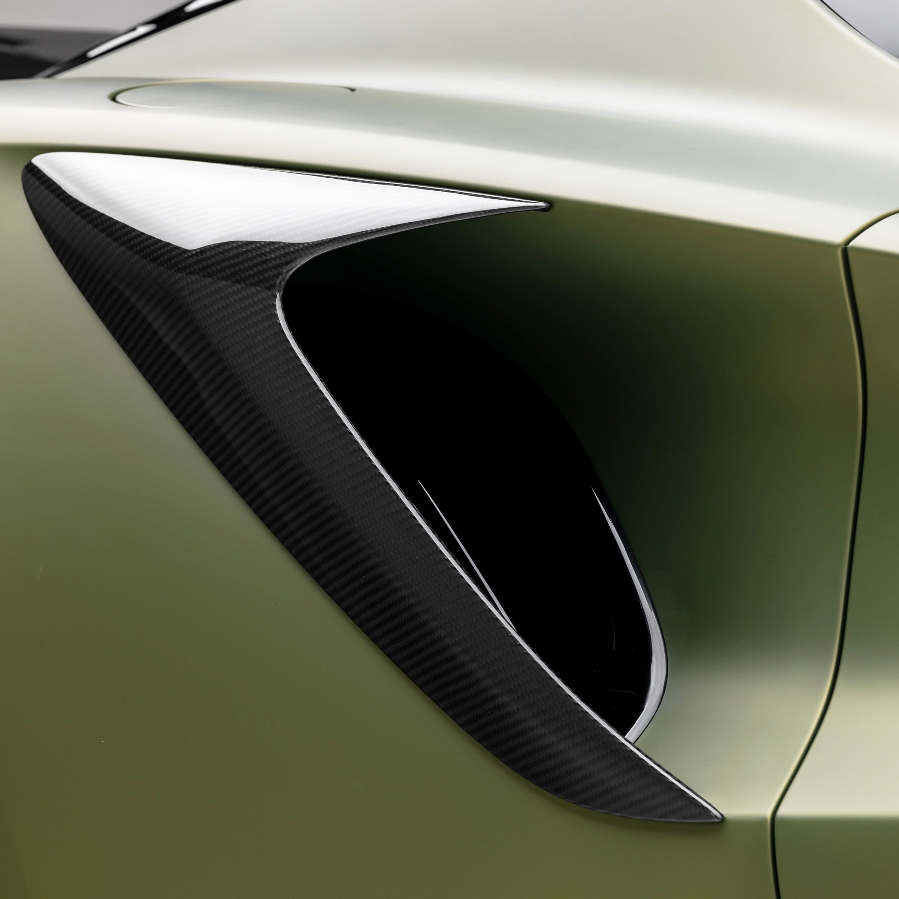 Emira side intake opening in carbon, angled close-up
