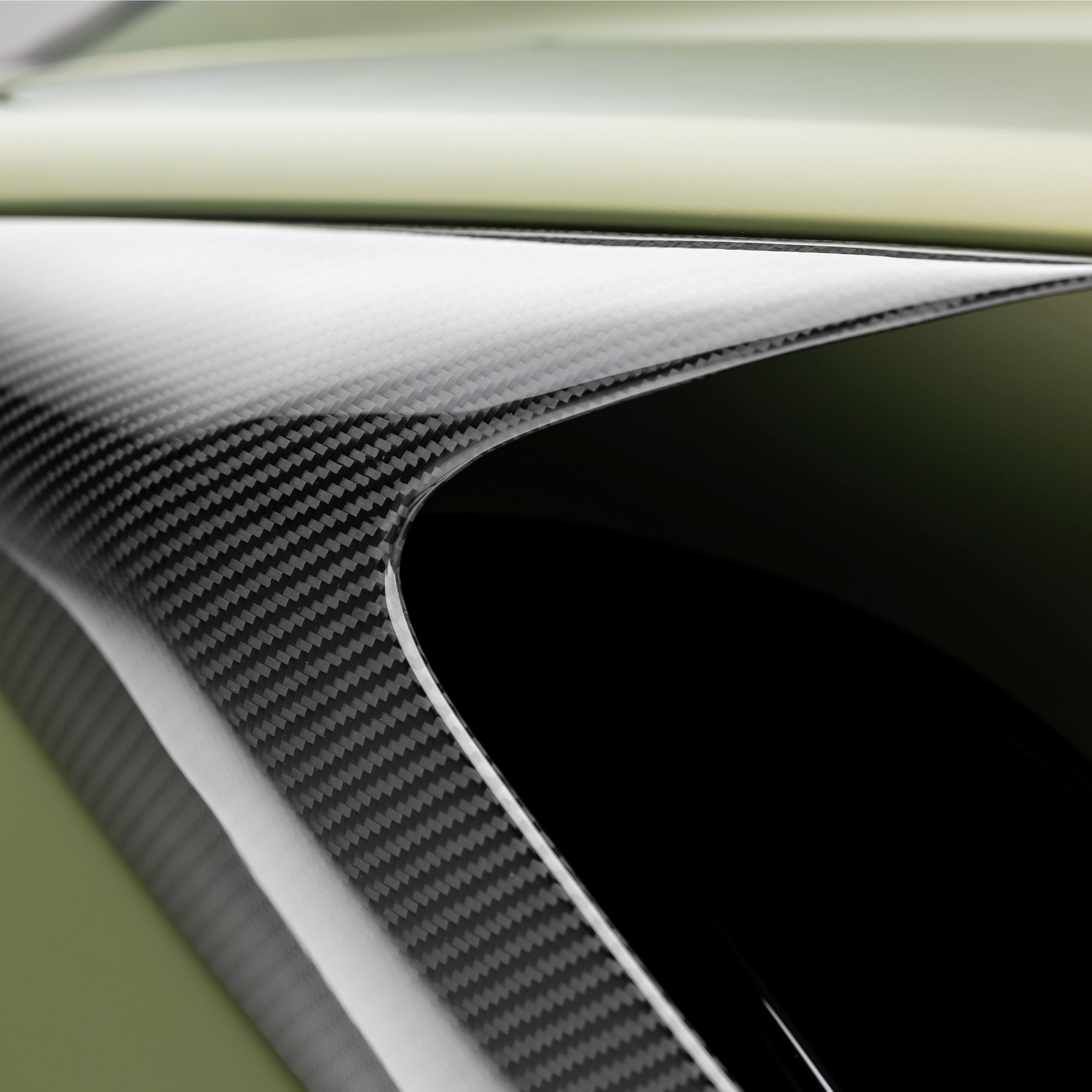 2x2 carbon weave inside Emira side intake, macro